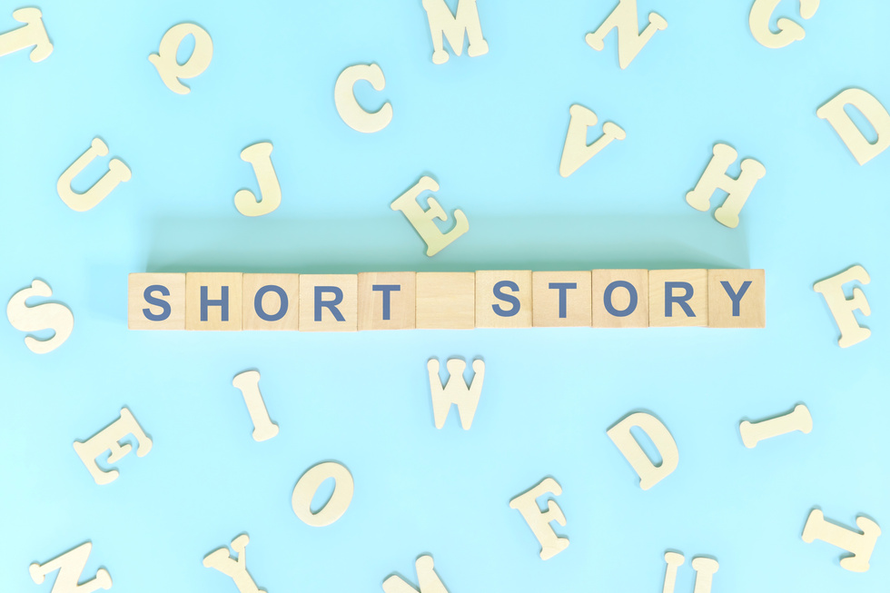 Short story narrative form in english literature concept. Wooden blocks typography word flat lay in blue background.